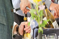 Man popping cork on wine bottle